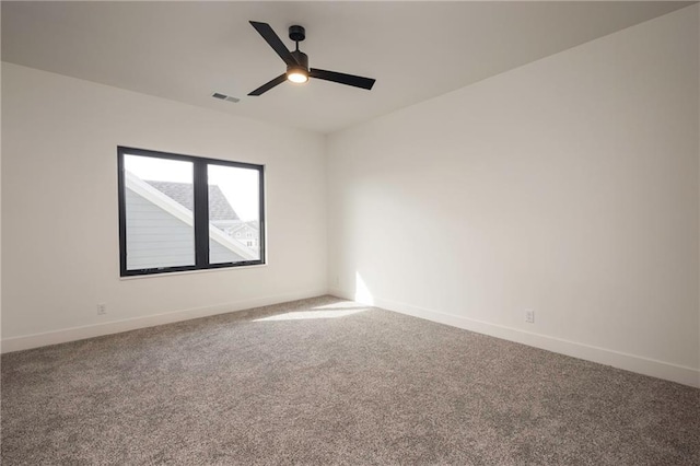 spare room featuring ceiling fan and carpet