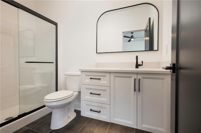 bathroom featuring walk in shower, vanity, and toilet