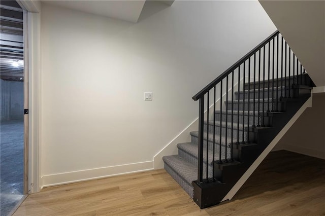 stairs featuring hardwood / wood-style floors