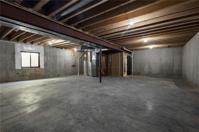 basement with water heater, heating unit, and electric panel