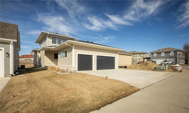 view of front of property with a garage and a front lawn