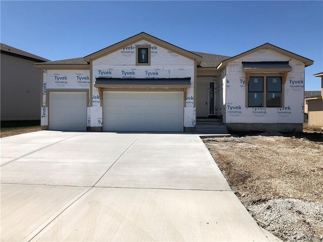 property under construction with an attached garage and concrete driveway