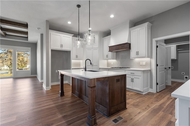 17178 S Heatherwood St, Olathe, KS 66062 - kitchen with a sink, custom exhaust hood, decorative backsplash, a center island with sink, and dark wood-style floors