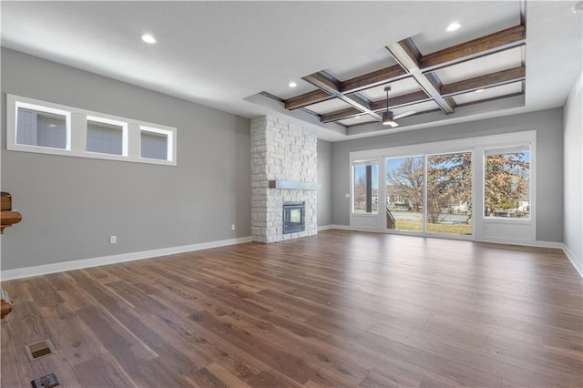 17178 S Heatherwood St, Olathe, KS 66062 - unfurnished living room featuring baseboards, a stone fireplace, wood finished floors, beamed ceiling, and recessed lighting