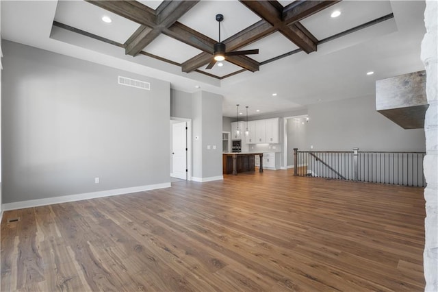 17178 S Heatherwood St, Olathe, KS 66062 - unfurnished living room featuring coffered ceiling, baseboards, wood finished floors, a ceiling fan, and beamed ceiling