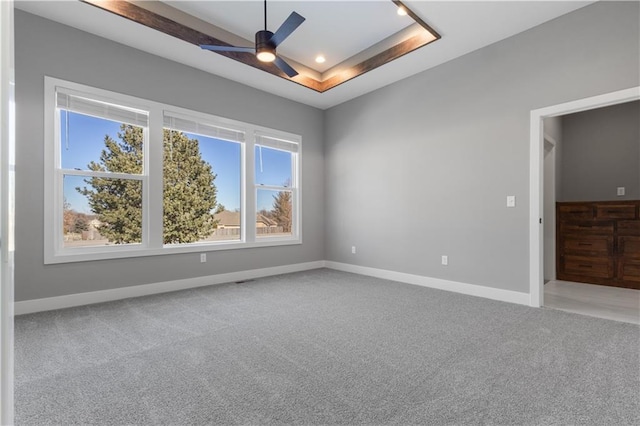 17178 S Heatherwood St, Olathe, KS 66062 - spare room with a tray ceiling, light carpet, baseboards, ceiling fan, and recessed lighting