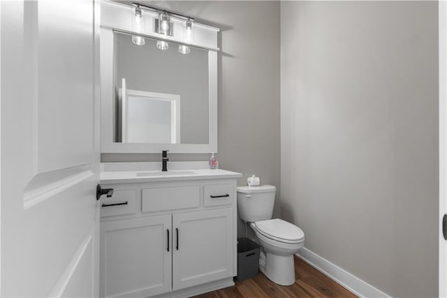 17178 S Heatherwood St, Olathe, KS 66062 - half bath with toilet, wood finished floors, vanity, and baseboards