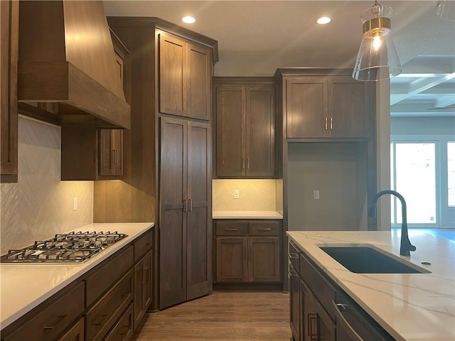 17178 S Heatherwood St, Olathe, KS 66062 - kitchen featuring stainless steel gas stovetop, custom exhaust hood, recessed lighting, wood finished floors, and decorative light fixtures
