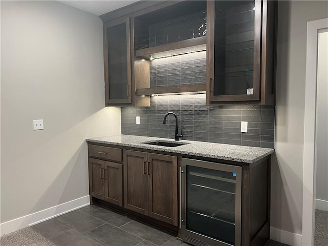 17178 S Heatherwood St, Olathe, KS 66062 - bar featuring beverage cooler, tasteful backsplash, and dark tile patterned flooring