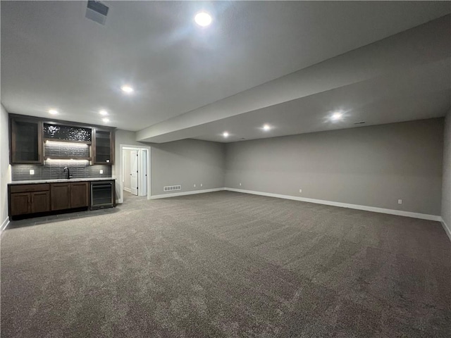 17178 S Heatherwood St, Olathe, KS 66062 - unfurnished living room featuring beverage cooler, carpet floors, recessed lighting, and bar
