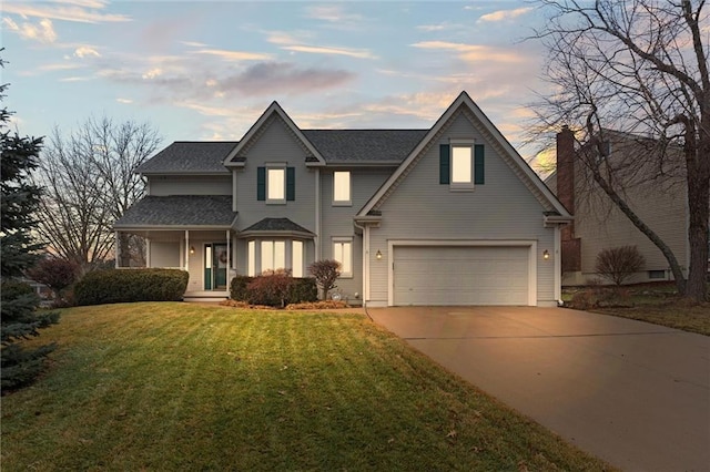 view of front of house with a yard and a garage