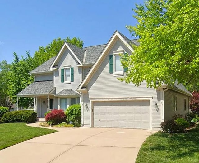 view of front facade featuring a garage and a front lawn