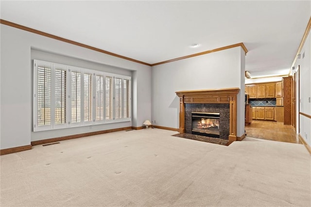 unfurnished living room with crown molding, a fireplace, and light carpet