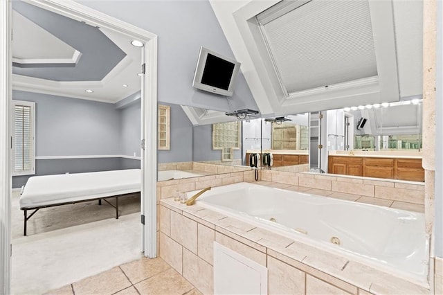 bathroom with crown molding, vanity, tile patterned flooring, and tiled tub