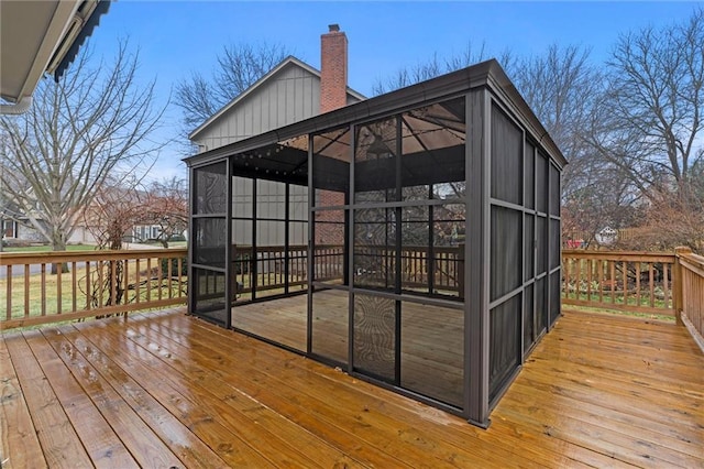 wooden deck with a sunroom