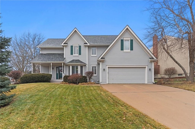 traditional-style home featuring a garage, driveway, and a front yard