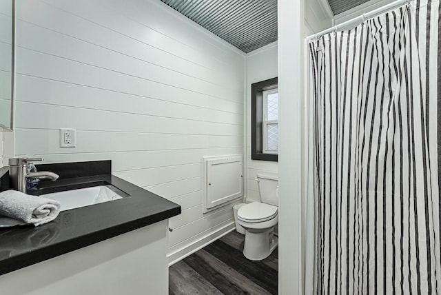 bathroom with a shower with shower curtain, vanity, toilet, and hardwood / wood-style floors