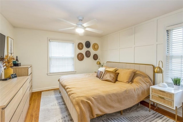 bedroom with ceiling fan and light wood-type flooring