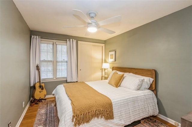 bedroom with wood-type flooring and ceiling fan