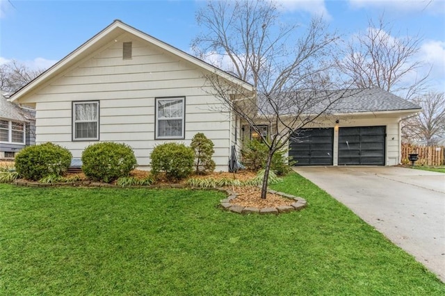 view of front of house with a garage and a front lawn