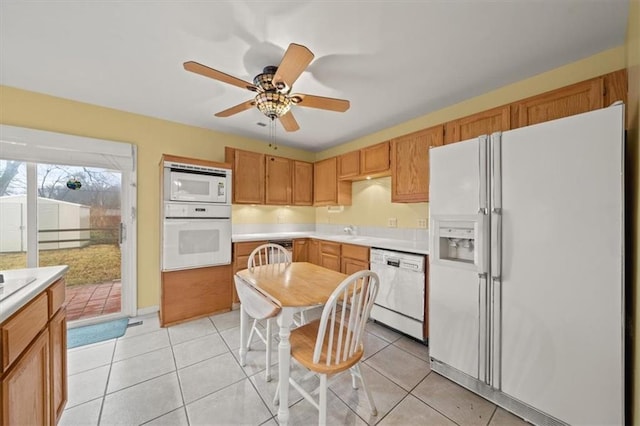 kitchen with white appliances, light countertops, a ceiling fan, and light tile patterned flooring