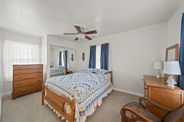 bedroom with visible vents, baseboards, a ceiling fan, light colored carpet, and a closet