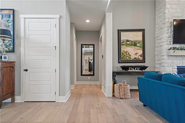 hallway featuring recessed lighting, light wood-style flooring, and baseboards