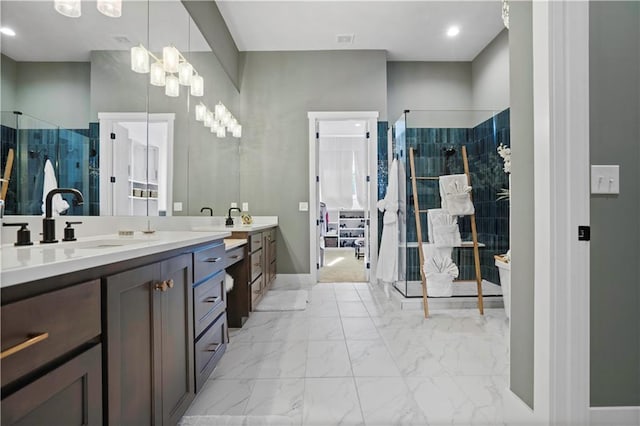 full bath with marble finish floor, a shower stall, and vanity