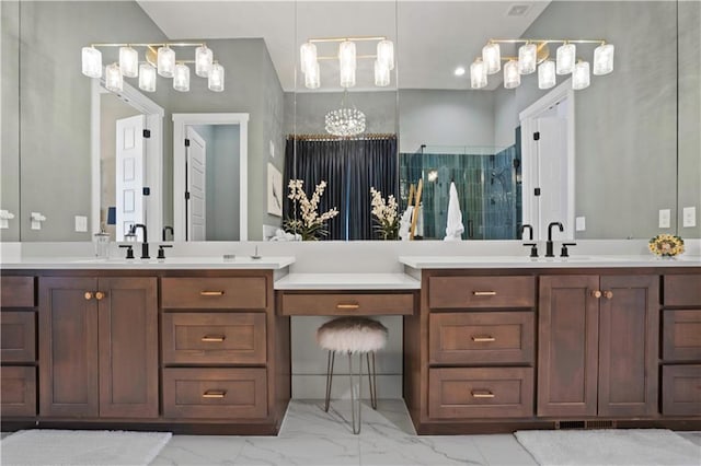 bathroom with double vanity, marble finish floor, a sink, and tiled shower