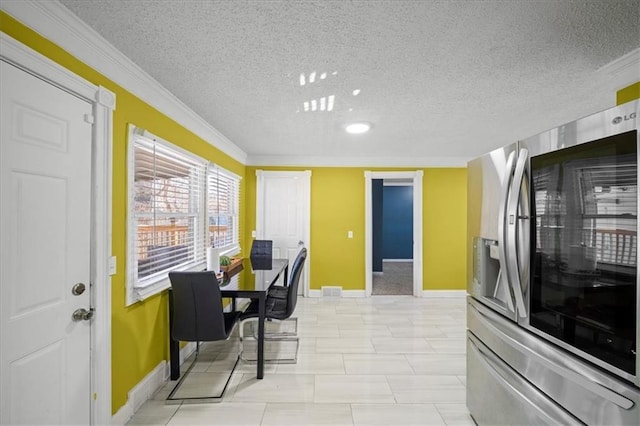 dining space featuring crown molding and a textured ceiling