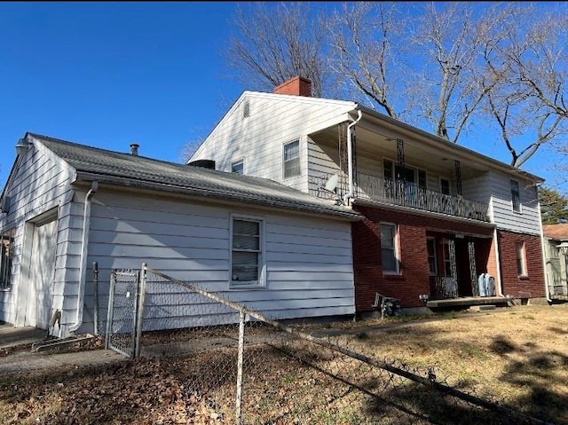 back of house with a balcony