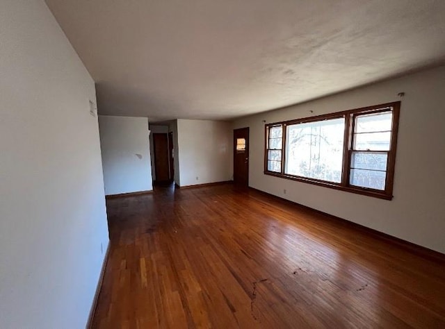 unfurnished room featuring dark wood-type flooring