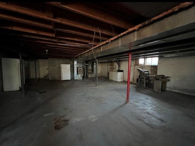 basement featuring separate washer and dryer and heating unit