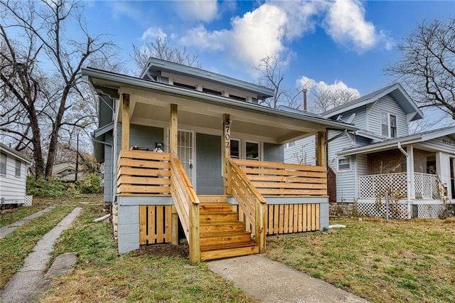 view of front facade with a front lawn and a porch