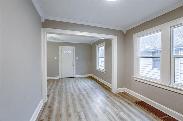 foyer featuring crown molding and light hardwood / wood-style floors