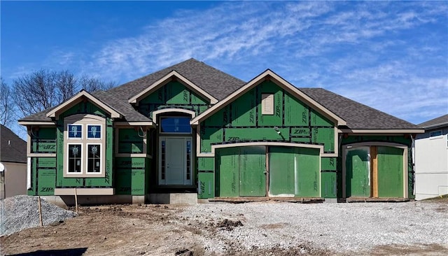 property in mid-construction featuring a shingled roof