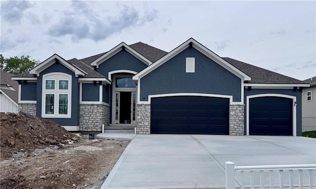 10332 N Potter Ave, Kansas City, MO 64157 - view of front of property featuring an attached garage, stucco siding, stone siding, and driveway
