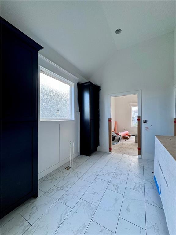10332 N Potter Ave, Kansas City, MO 64157 - bedroom featuring light marble finish floors, multiple windows, and high vaulted ceiling