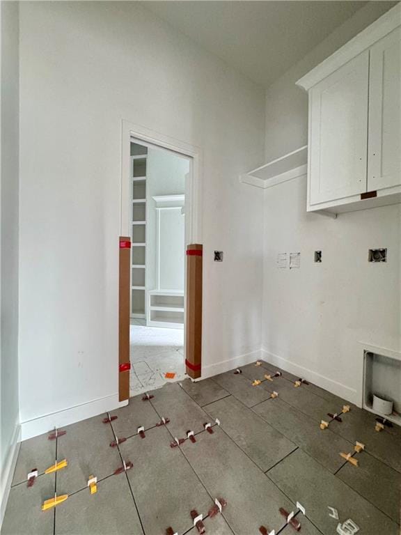 10332 N Potter Ave, Kansas City, MO 64157 - laundry room featuring cabinet space and baseboards