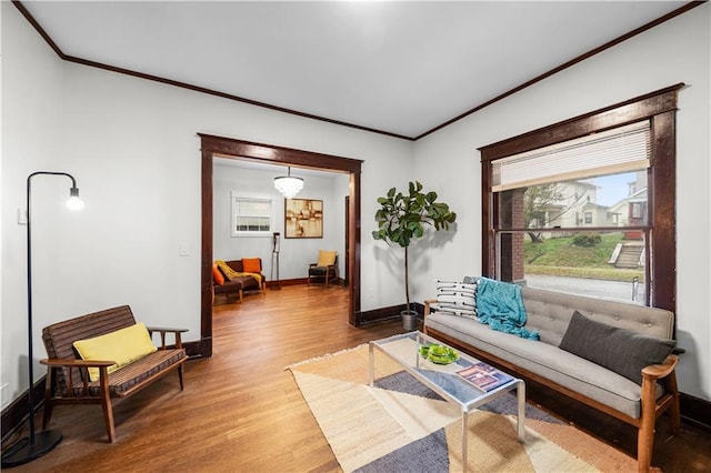 living room with hardwood / wood-style flooring and crown molding