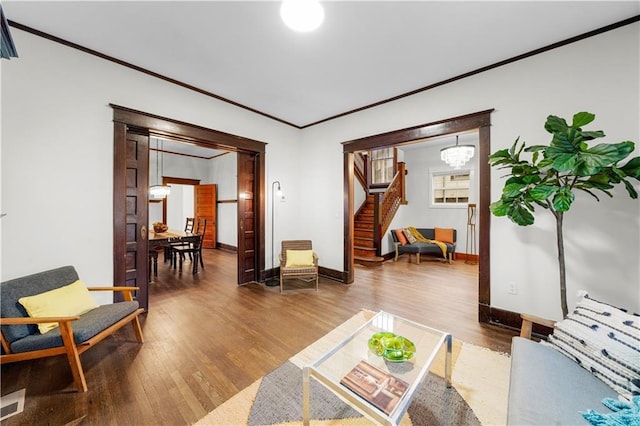 living room featuring crown molding and hardwood / wood-style floors