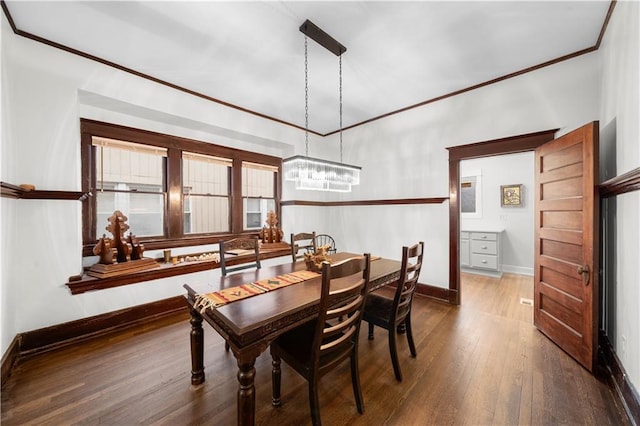 dining room featuring dark hardwood / wood-style flooring and crown molding