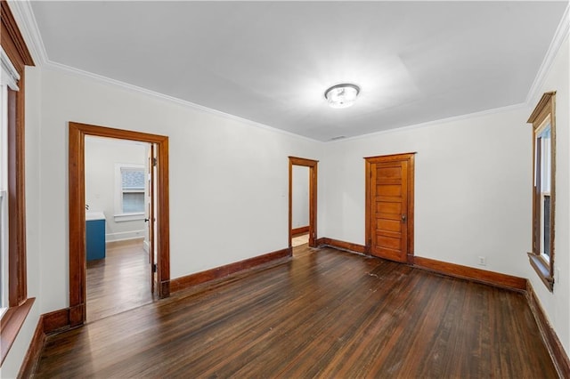 unfurnished room with ornamental molding and dark wood-type flooring