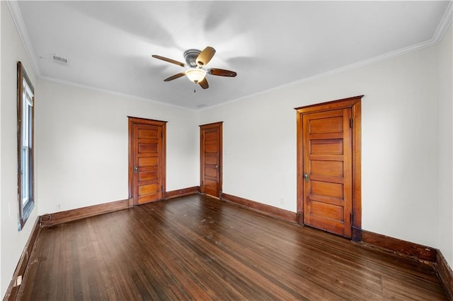 spare room featuring dark wood-type flooring, ornamental molding, and ceiling fan