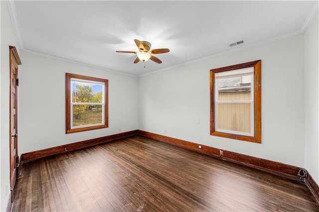 spare room featuring crown molding, dark wood-type flooring, and ceiling fan