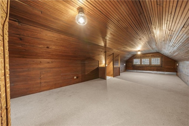 bonus room with wooden ceiling, vaulted ceiling, carpet, and wood walls