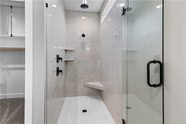 bathroom with a shower with shower door