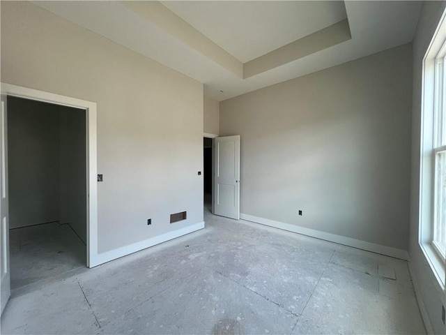 17154 S Heatherwood St, Olathe, KS 66062 - unfurnished bedroom featuring baseboards and a tray ceiling