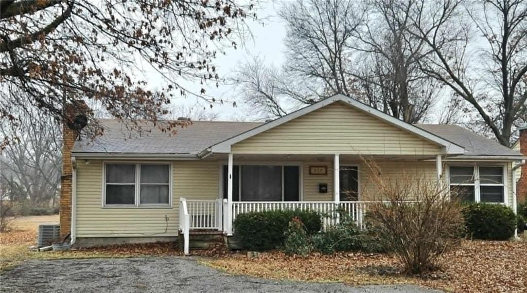 view of front of house with cooling unit and covered porch