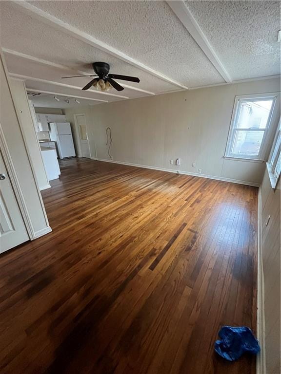 unfurnished living room featuring ceiling fan, wood-type flooring, and a textured ceiling